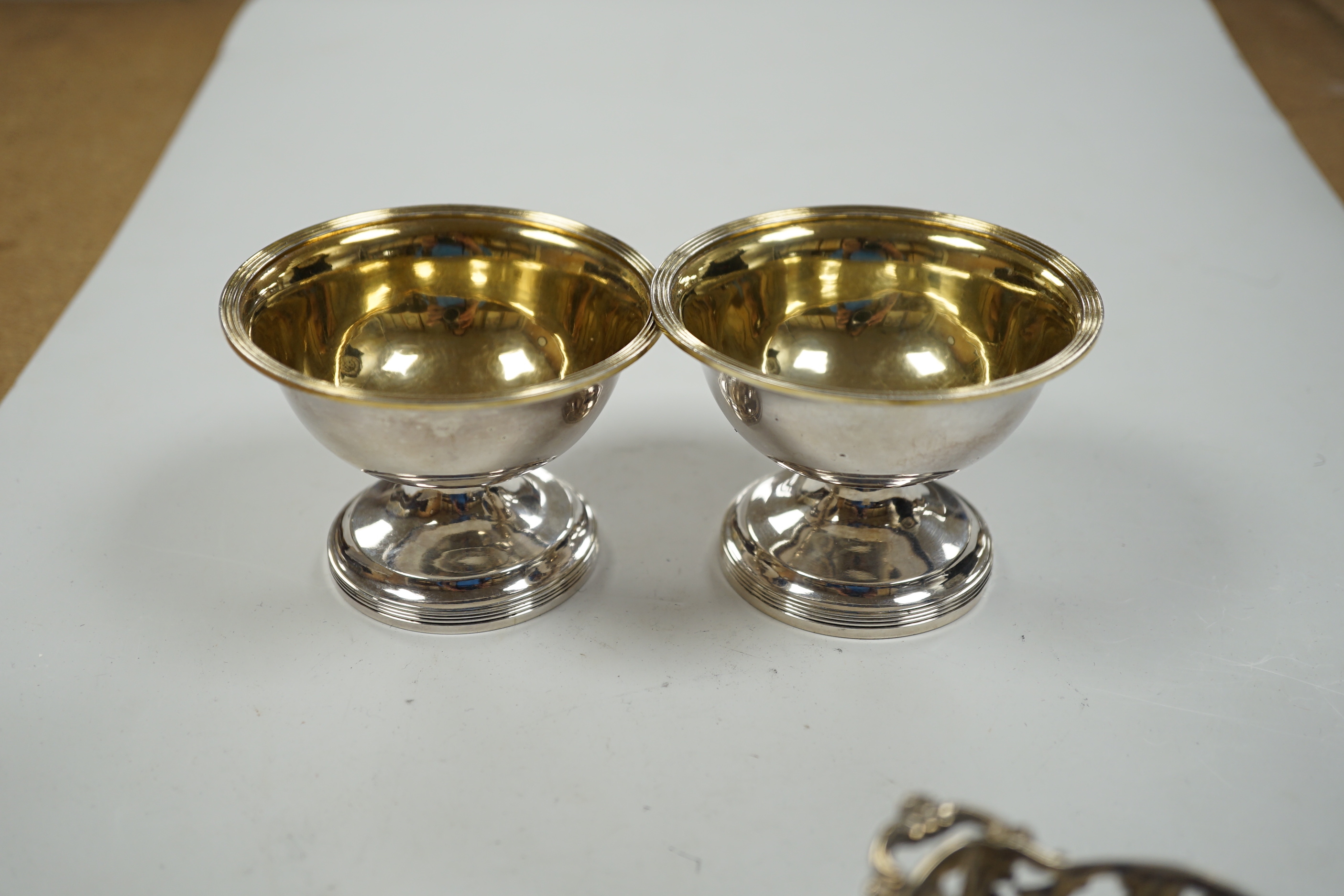 A pair of George III silver circular pedestal salts, John Kidder?, London, 1799, diameter 78mm and a small Hanau silver two handled dish.